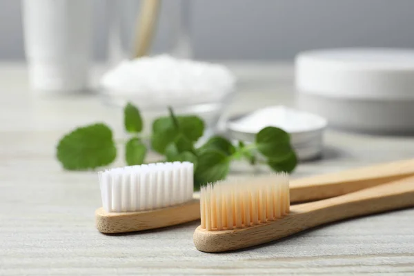 Toothbrushes Green Herbs Wooden Table Closeup — Stock Photo, Image