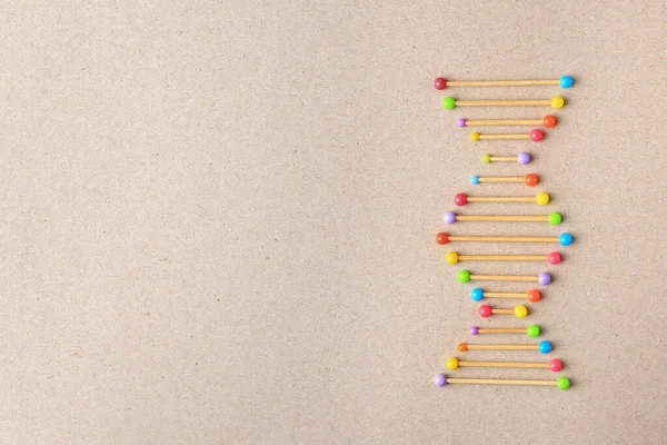 Model of DNA molecular chain on beige background, top view. Space for text