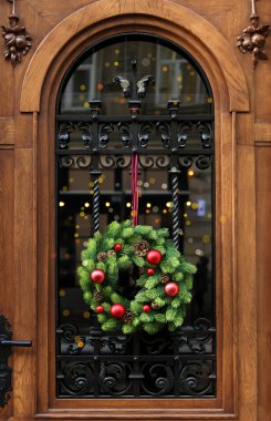 Beautiful Christmas wreath hanging on wooden door