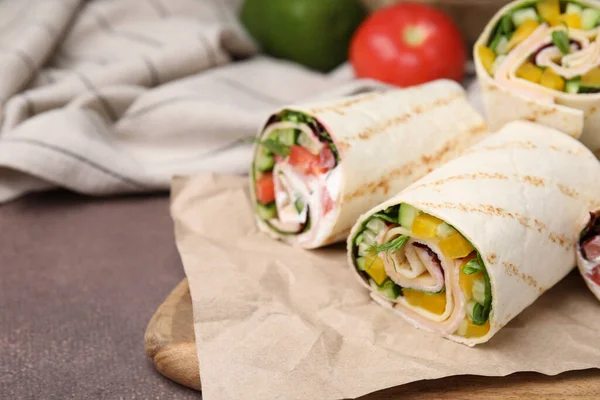 stock image Delicious sandwich wraps with fresh vegetables on grey table, closeup