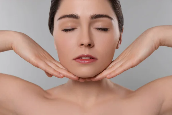 Young Woman Massaging Her Face Grey Background — 스톡 사진