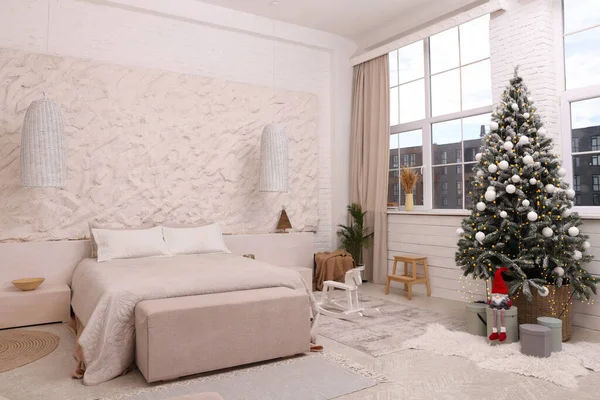 クリスマスツリーとお祝いの装飾付きのベッドルームのインテリア — ストック写真