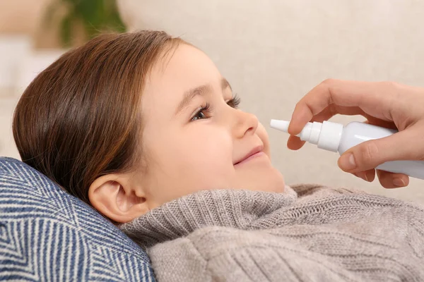 Mother Using Nasal Spray Treat Her Little Daughter Sofa Closeup — Stock Photo, Image