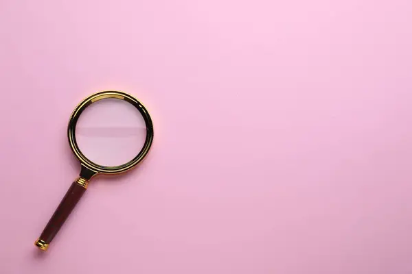 stock image Magnifying glass on pink background, top view. Space for text