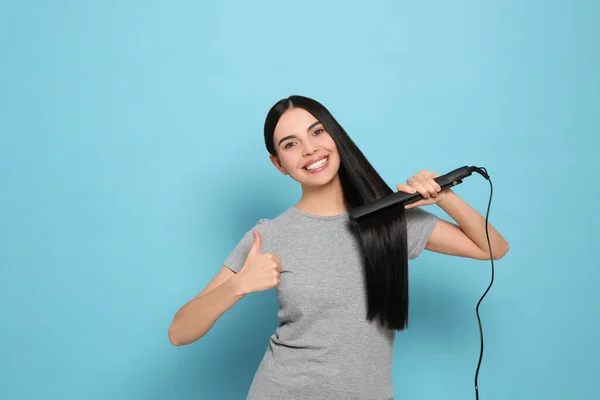 Beautiful Happy Woman Showing Thumbs While Using Hair Iron Light — Stock Photo, Image