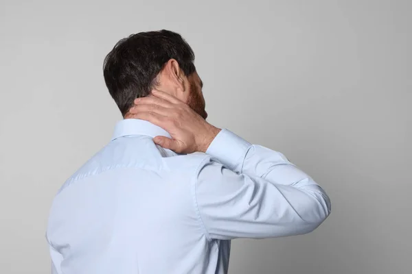Man Suffering Pain His Neck Light Background Back View Arthritis — Stock Photo, Image