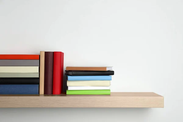 Many Hardcover Books Wooden Shelf White Wall Space Text — Stock Photo, Image