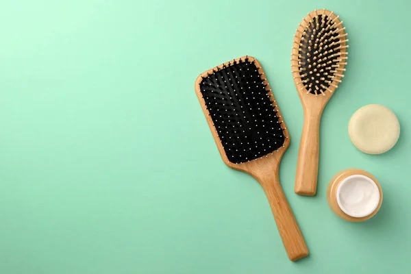 Wooden Hairbrushes Different Cosmetic Products Turquoise Background Flat Lay Space — Stock Photo, Image