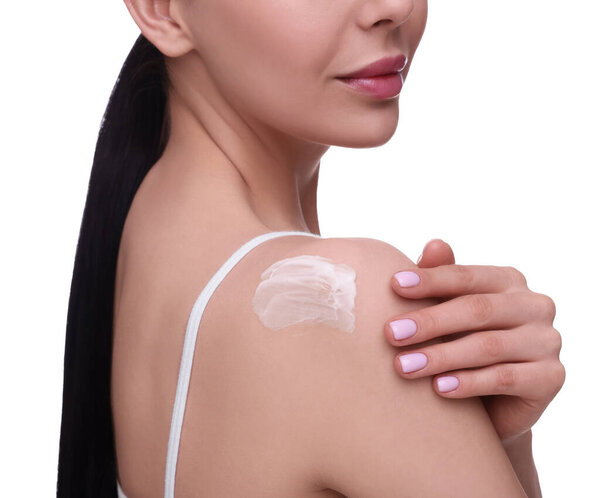 Woman with smear of body cream on her shoulder against white background, closeup
