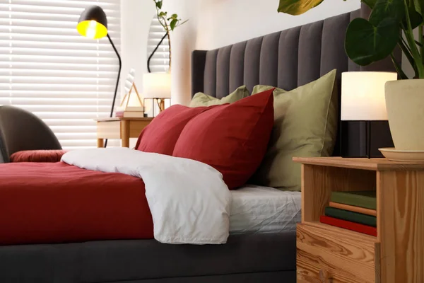 快適なベッドルーム ナイトスタンド 緑の観葉植物とスタイリッシュなベッドルームのインテリア — ストック写真