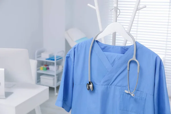 Blue Medical Uniform Stethoscope Hanging Rack Clinic Closeup Space Text — Photo