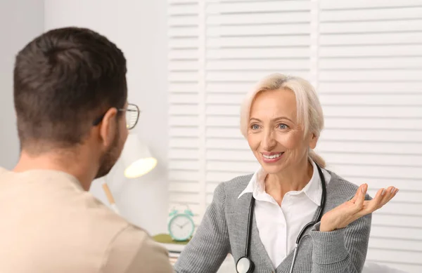 stock image Professional female doctor consulting patient in clinic