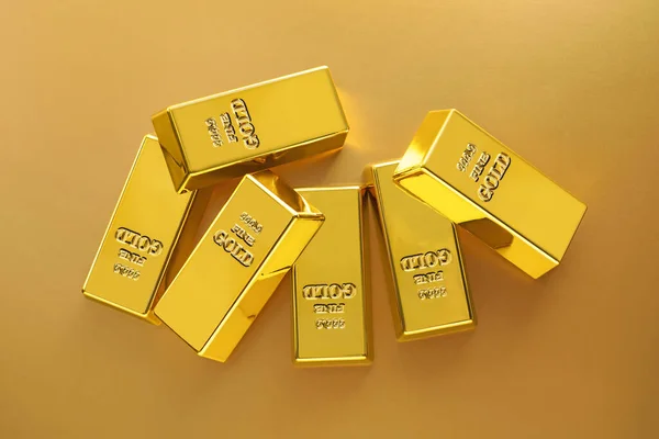 Shiny gold bars on color background, flat lay