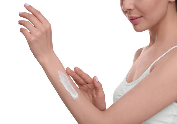 Woman with smear of body cream on her arm against white background, closeup