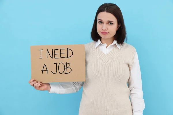 Young Unemployed Woman Holding Sign Phrase Need Job Light Blue — Stock Photo, Image