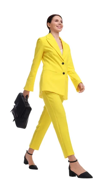 白い背景を歩くブリーフケース付き黄色のスーツの美しいビジネス女性 低角度ビュー — ストック写真