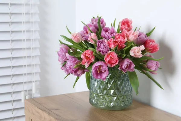 stock image Beautiful bouquet of colorful tulip flowers on wooden table indoors