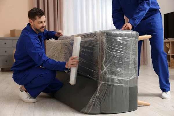 Male Movers Stretch Film Wrapping Sofa New House — Foto de Stock