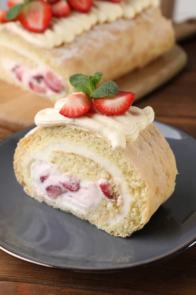 stock image Delicious cake roll with strawberries and cream on gray plate