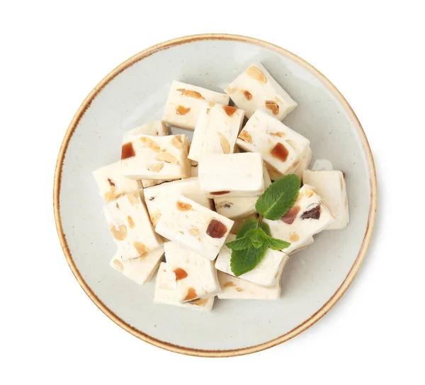 stock image Plate with pieces of delicious nougat and mint isolated on white, top view