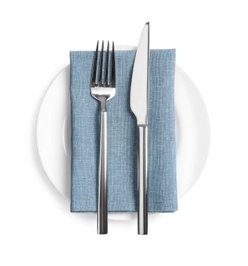 Clean plate and shiny cutlery on white background, top view