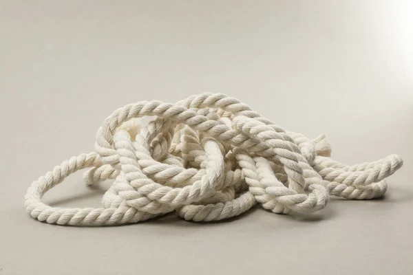 Bundle of hemp rope on light grey background