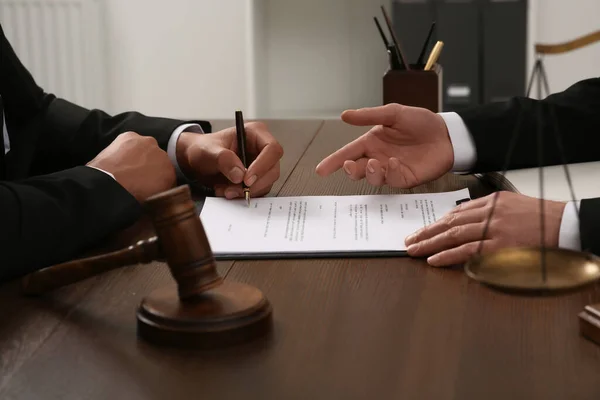 stock image Law and justice. Lawyers working with documents at wooden table in office, closeup