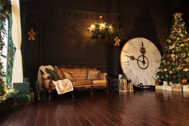 Stylish room interior with Christmas tree, big vintage clock and festive decor