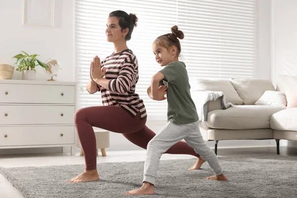 Young Mother Her Daughter Practicing Yoga Together Home — Fotografia de Stock