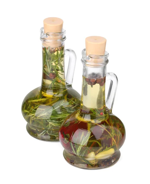 stock image Glass jugs of cooking oils with spices and herbs on white background