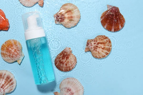 Bottle Face Cleansing Product Seashells Water Light Blue Background Flat — Stock Photo, Image
