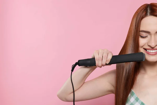 Beautiful Woman Using Hair Iron Pink Background Closeup Space Text — Stock Photo, Image