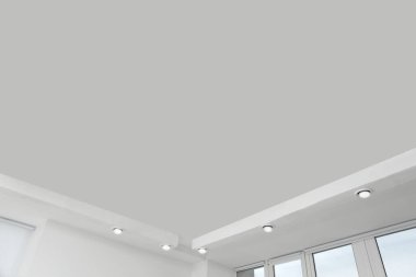 White ceiling with modern lighting in office