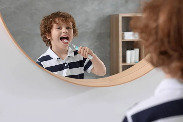 Roztomilý Chlapeček Čištění Zubů Elektrickým Kartáčkem Blízkosti Zrcadla Koupelně — Stock fotografie