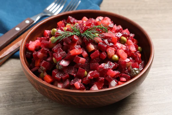 stock image Bowl of delicious fresh vinaigrette salad on wooden table, closeup