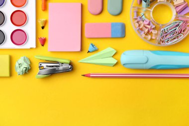 Flat lay composition with different school stationery on yellow background, space for text. Back to school