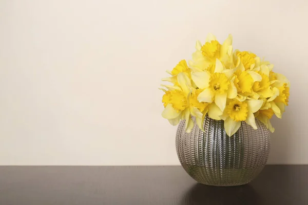 stock image Bouquet of beautiful yellow daffodils in vase on table. Space for text