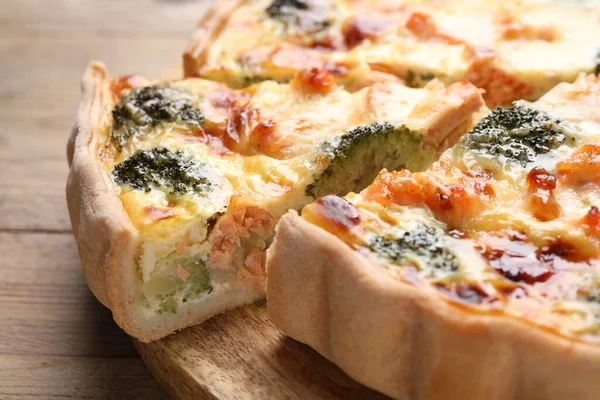 stock image Delicious homemade quiche with salmon and broccoli on table, closeup