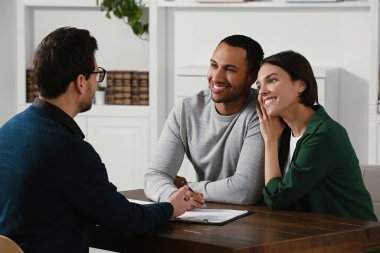 Professional notary working with couple in office