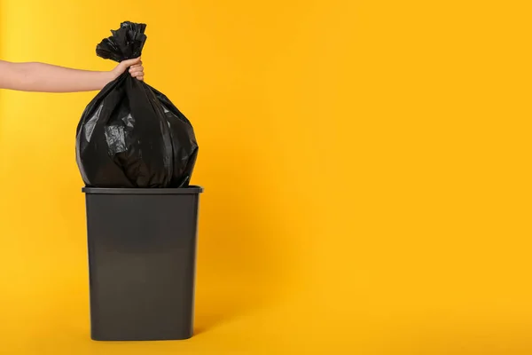 Woman Holding Trash Bag Full Garbage Bucket Orange Background Closeup — Stock Photo, Image