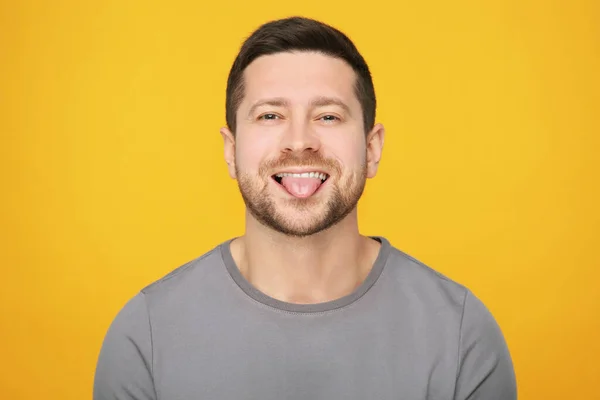 Happy Man Showing His Tongue Orange Background — Stock Photo, Image
