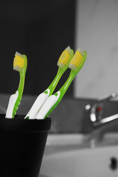 Light Green Toothbrushes Black Toothbrush Holder Indoors — Stock Photo, Image