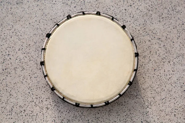 Drum on grey table, top view. Percussion musical instrument