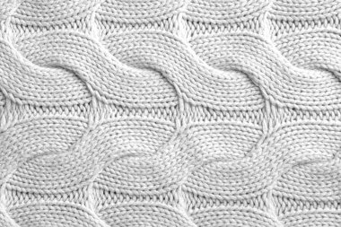 Arka plan olarak desenli beyaz örülmüş kumaş, üst görünüm