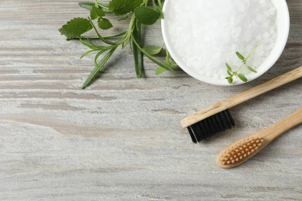 Toothbrushes Green Herbs Sea Salt Wooden Table Flat Lay Space — Stock Photo, Image