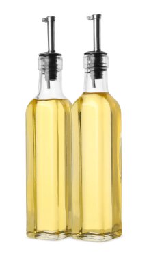 Glass bottles of cooking oil on white background