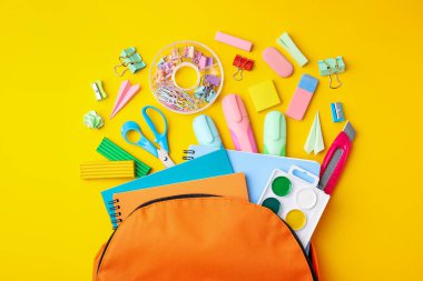 Flat lay composition with different school stationery on yellow background. Back to school