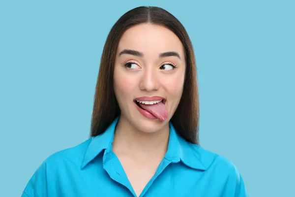 Dilini Açık Mavi Arka Planda Gösteren Mutlu Kadın — Stok fotoğraf