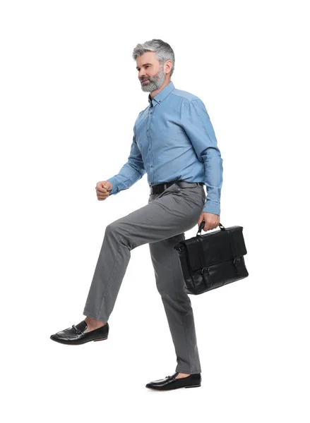 Mature businessman in stylish clothes with briefcase on white background