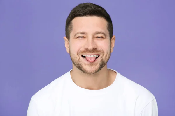 Happy Man Showing His Tongue Purple Background — Stock Photo, Image